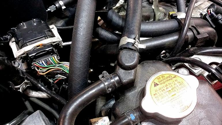 Loosen the tension on the spring clamp that is on the upper factory turbo coolant hose. Proceed to pull the factory hose off of the coolant expansion tank.