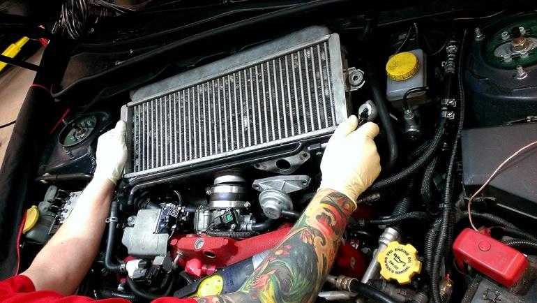 Grab the intercooler by the sides and carefully wiggle it out of the engine bay.