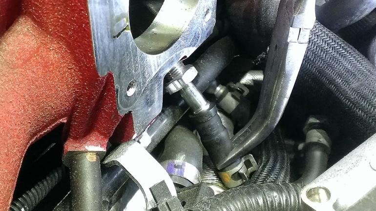 If the throttle body is stuck, gently tap around the sides with a rubber mallet