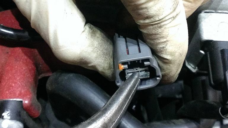 Note: There are two ports next to each other on the valve cover. One port is larger than the other.