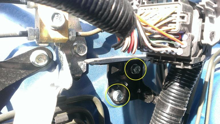 Using a 10mm socket, remove the 2 bolts that hold the wiring harness
