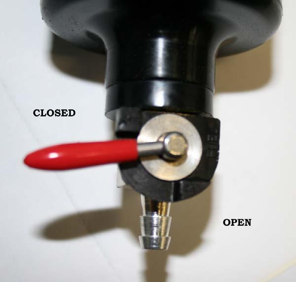 To drain the oil catch can, turn the lever to the open position. This catch can should be drained every oil change.