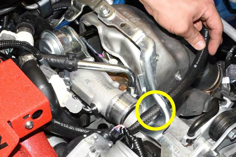 the ½ port on the plastic drain fitting located on the engine block.