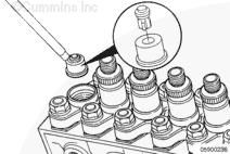 Page 12 of 22 Remove the delivery valve holder by carefully tipping the holder outboard with one hand while using the other hand to hold the spring, fill piece, and any shims from slipping out of the
