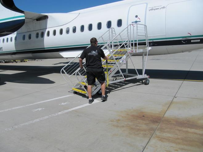 Push the Q-Stair up to the aircraft L-2 door When in position depress the brake arm latch and