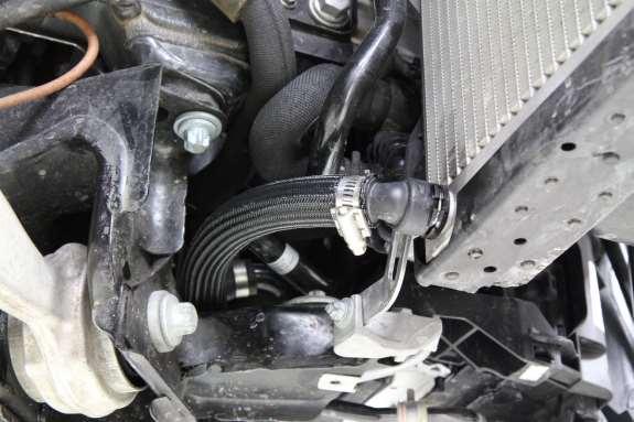 l) Once the coolant hose is routed and secure, reinstall the front bumper, wheel well liners,