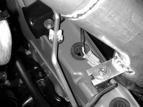 g) Inside the cavity behind the bumper, unsnap the wiring loom from the