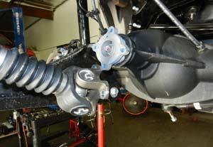 (Fig 9) With the axle fully supported, remove the lower shock bolts. FIG 9 Remove the sway bar from the frame.