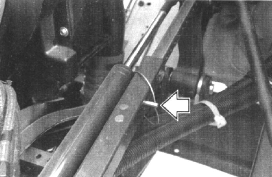 Put one end of the pump handle into the pump and operate the pump in an up and down motion. As hydraulic pressure increases, the cab tilt cylinders will start to move the cab up.