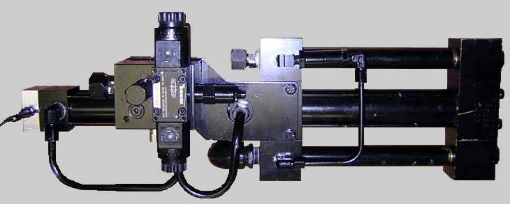 The hydraulic end of the pump is painted steel and controls the speed and direction of both cylinders.