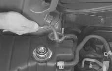 3. Fill the coolant surge tank with the proper mixture to the full cold fill mark on the side of the coolant surge tank. 4.