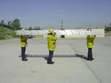 On the command BEAM LADDER", both firefighters grasp the top beam of the ladder with their left hand.