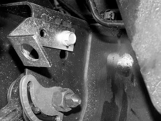 35. Attach the caliper to the new steering knuckle with the original mounting hardware. Torque bolts to 125 ft-lbs. 36. Carefully remove the metal retainer bracket from the factory rubber brake line.