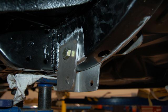 Do this on each side of the vehicle. The measurement to the lower trailing arm hole center should be 55