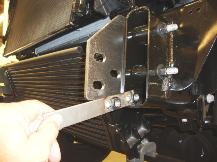 Leave the nuts and paired bolts loose for final adjustment. Repeat this step to install the remaining frame bracket on the passenger side.