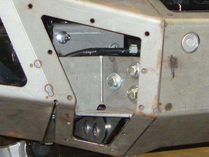 Install a 3/8 flat washer on one of the 3/8 x 5 hex bolts and position the bolt through the lower set of holes in the tow hook frame stanchion with the threads protruding toward the outside of