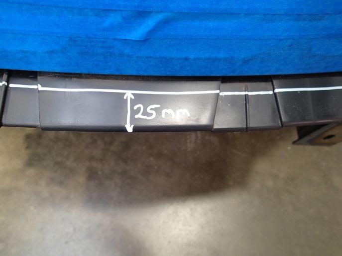 26. Using a marker pen, mark a line, parallel to the front edge of the lower bumper