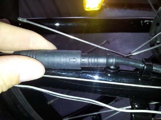 Tighten up both nuts until the wheel is safely installed, cover with black caps, re-install the derailleur protector and reconnect the motor wire to the female end: both arrows