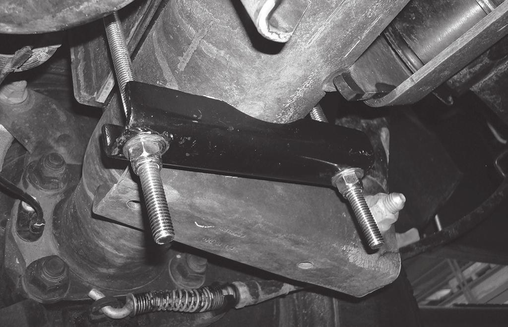 lock nut (U). Torque to 16 lb.-ft. Repeat for the other side. It may be necessary to use a 9/16 crows foot adapter to torque the nut underneath the frame. 4.
