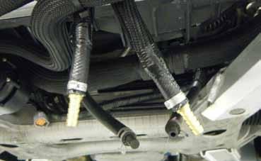 35. Place the power steering cooler back into place on the impact bar. As indicated previously, it is recommended to have the hoses point inwards towards each other.