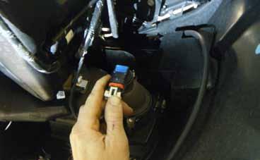 13. Disconnect the electrical connector from each fog light. 14. The washer fluid pump is located on the passenger side of the vehicle behind the fog light area.