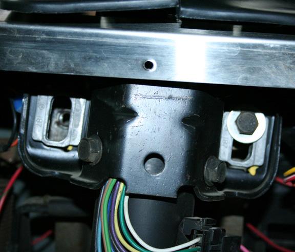 Though it is possible to pull the column through the hole in the dash with the mount still attached, it is easier to do if you remove the electric part of the ignition switch first using a 5/16 nut