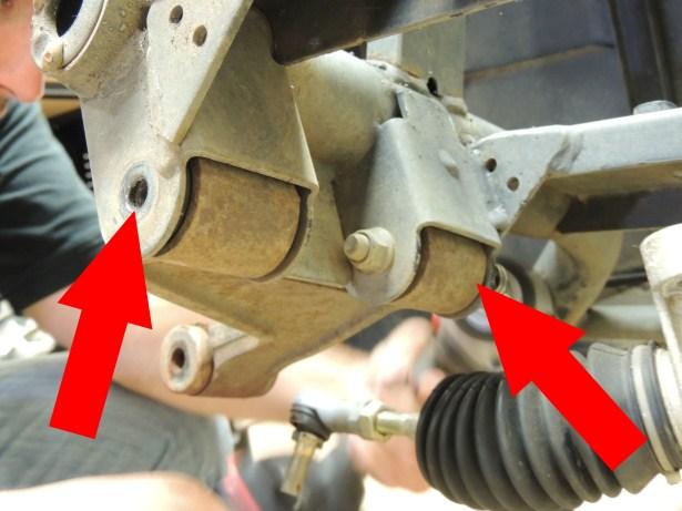 Remove the shock assemblies by removing the bolts connecting them to the frame (blue