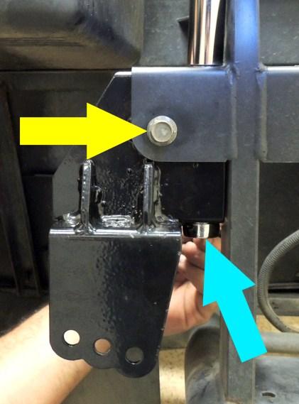 Insert the Original Bolt from the upper portion of the shock into the hole. 5. Insert a marking device through the thru holes in the shock tower (blue arrow). Mark a drill location on the frame. 6.
