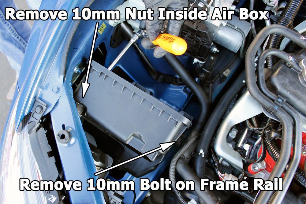 6. Remove front section of air box from vehicle. 7. Using a 10mm socket, remove (2) nuts securing upper air box mounting bracket and rubber mount.