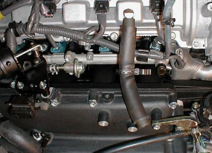 69. Re-install the OE breather hose on the passenger-side cam cover. Connect it to the cam cover only at this time (Figure 75).