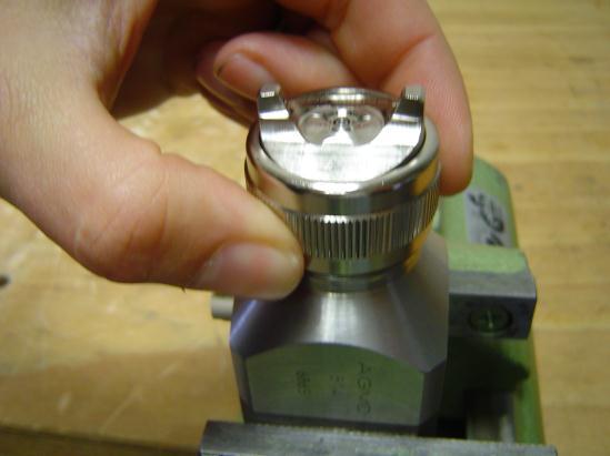 23. Tighten the air cap with the retaining