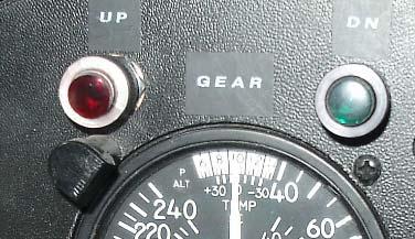 Gear indications. Gear down and locked: The position of the gear is indicated by the lights on the panel above the airspeed indicator.