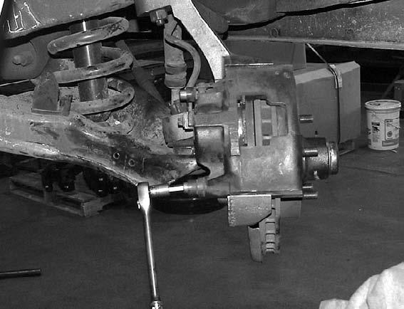 14. Slide the brake caliper onto the lift spindle. Make sure the brake pads are properly seated on the caliper. Thread the caliper bolts into the spindle and torque to factory specs.