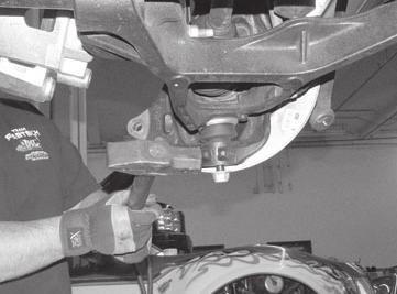 Remove the caliper from the rotor and place above the upper control arm during this portion of the installation. Remove brake rotor from the steering knuckle.
