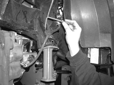 Picture showing where to install the nut tab into the frame 25. Torque the differential mount bolts to 90 ft. lbs. Torque the crossmember to frame bolts to 90 ft. lbs. Torque the ½ bolt on the skid plate to 55 ft.