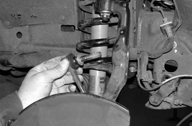 Remove the brake caliper and brake rotor from the steering knuckle and hang out of the way. Do not allow the brake caliper to hang from brake line. Remove the brake line brackets from the knuckle.
