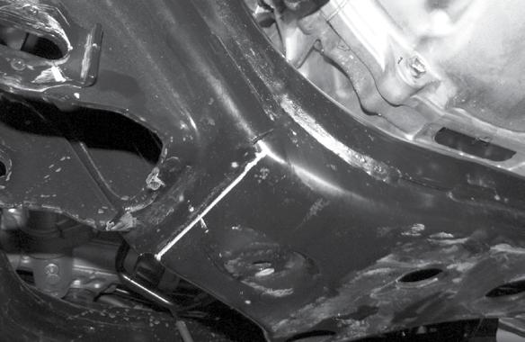 16. On the bottom of the crossmember, locate the factory weld at the lower control arm