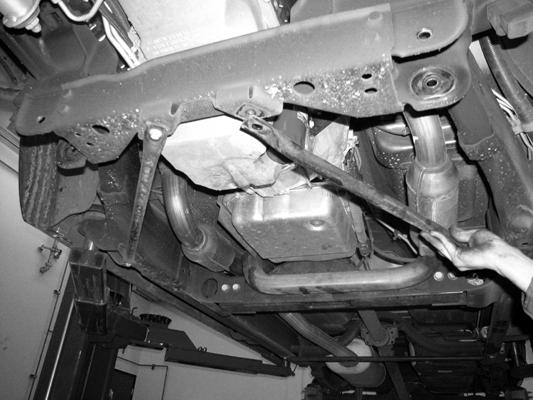 Locate the front mounts for the factory strut tubes previously removed. Mark as indicated above. With a die grinder and cutoff wheel cut the mounts from the frame. SEE PHOTO BELOW. 9.