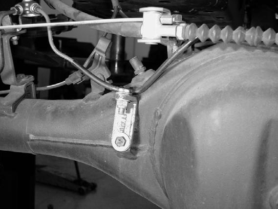 SEE PHOTO BELOW. 47. Locate and remove the factory center brake line tab. Locate the Fabtech relocating bracket FTS70015 and attach to the axle with factory hardware.