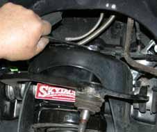 (See Photo # 16) Note: The OEM dust shields will not be reused. Install the OEM hub assemblies so the OEM ABS line is pointing toward the top of the new steering knuckle. 29.