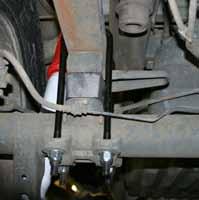 6. Disconnect the OEM rear brake line bracket from the frame rail. 7. While checking for appropriate slack in ABS lines, brake lines, differential breather hose, & etc.