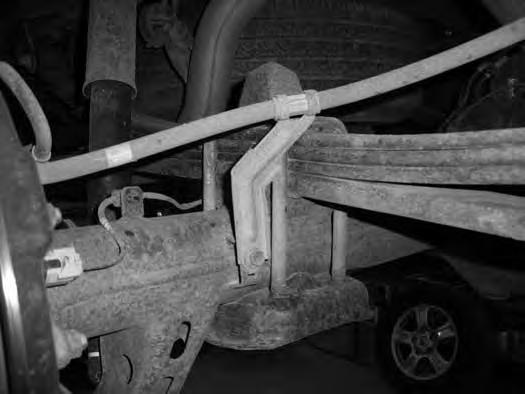 Support the rear axle with a floor jack and remove the factory rear shocks. Save the axle mount hardware, discard the upper hardware and shocks 4.