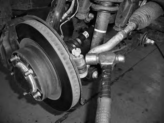 Strike the steering knuckle near the tie rod end to dislodge the taper Figure 3.