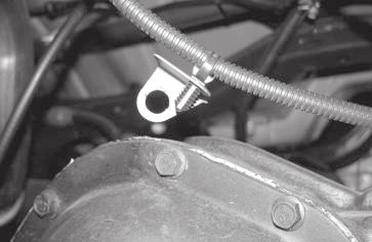 Remove the two nuts holding the E-Brake cable to the body of the Jeep and save.