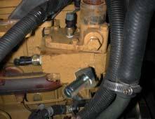 Install the supplied 1-inch to 3/4-inch plastic tee between the coolant tank and lower radiator hose diverter. Ensure that the 3/4-inch connection is facing towards the rear of the engine.