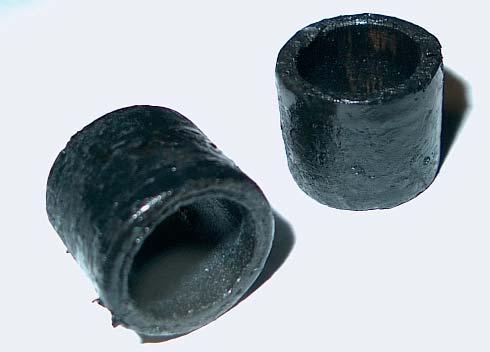 The damper rubber was originally vulcanized to the metal bushing, and grease inside the rack liquefied the rubber leaving the mess shown to the right of the screen. 2.