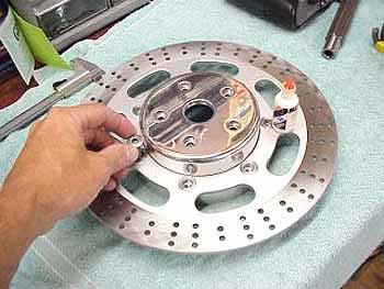 8- Place the brake rotor onto the Scootworks rotor adapter. Locate the seven allen head originally used to secure the rotor to the factory wheel.