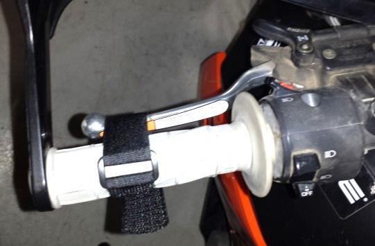 Use the straps to pull both levers as tight to the bar as possible as shown in the photos every time you park or leave the motorcycle. Refer to the Safety Information document for more information.