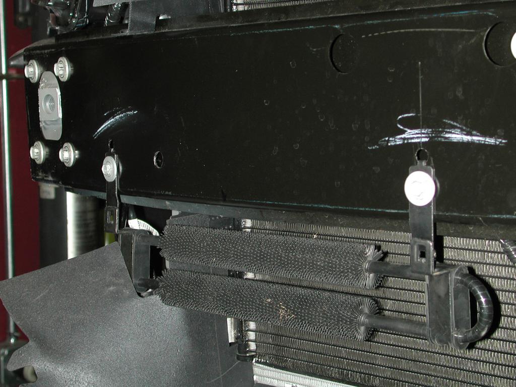 If the alignment is off, loosen the bumper mounting bolts to raise or lower the receiver braces.