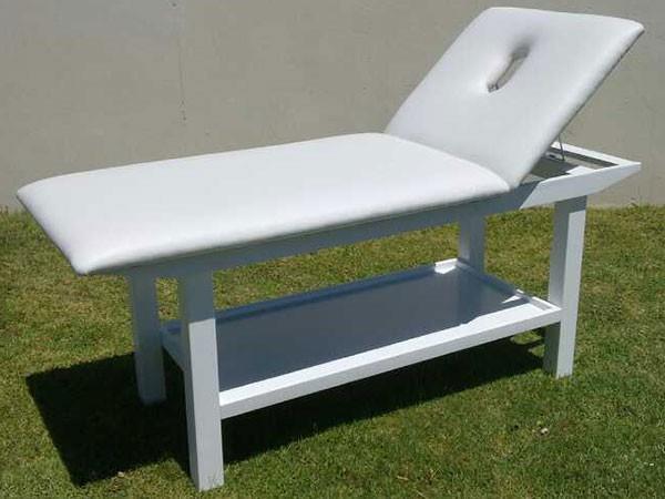 White Wooden framed massage table, bed/plinth Dimensions are 70 cm wide x 180 cm in length x 74 cm high from the floor to the top of the vinyl covering.